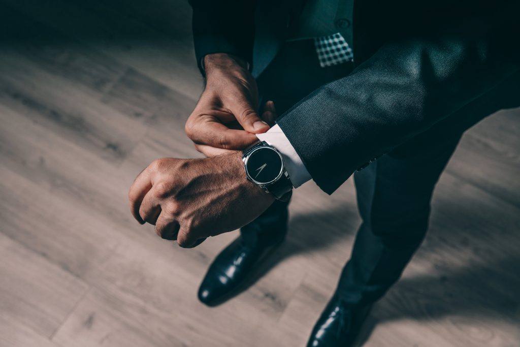 Agent in a suit adjusting his shirt cuff
